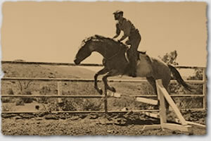The rider is jumping over a style as part of his personal advancement lesson.